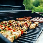 Selection of meat on a black BBQ grill